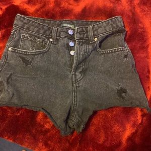Black with bought rips on it. Women’s high wasted denim shorts